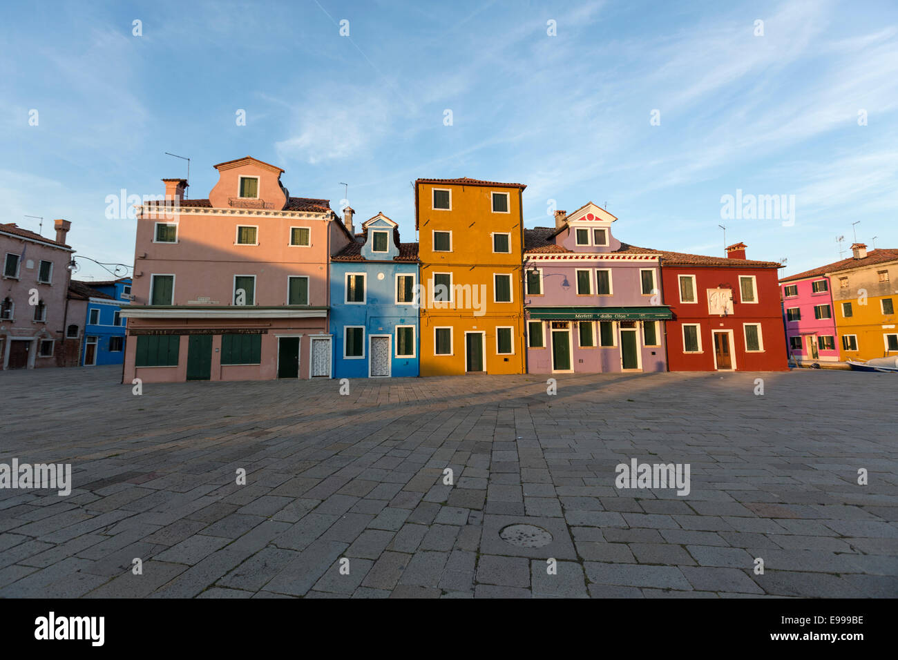 Piazza Baldassare Galuppi at sunset in Burano  known for its brightly coloured homes near Venice. Stock Photo