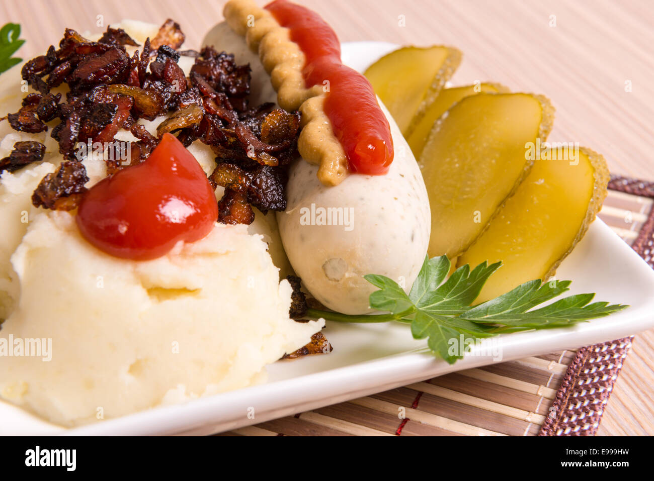 Bavarian or Munich sausage with mashed potatoes, cracklings and pickle Stock Photo Alamy
