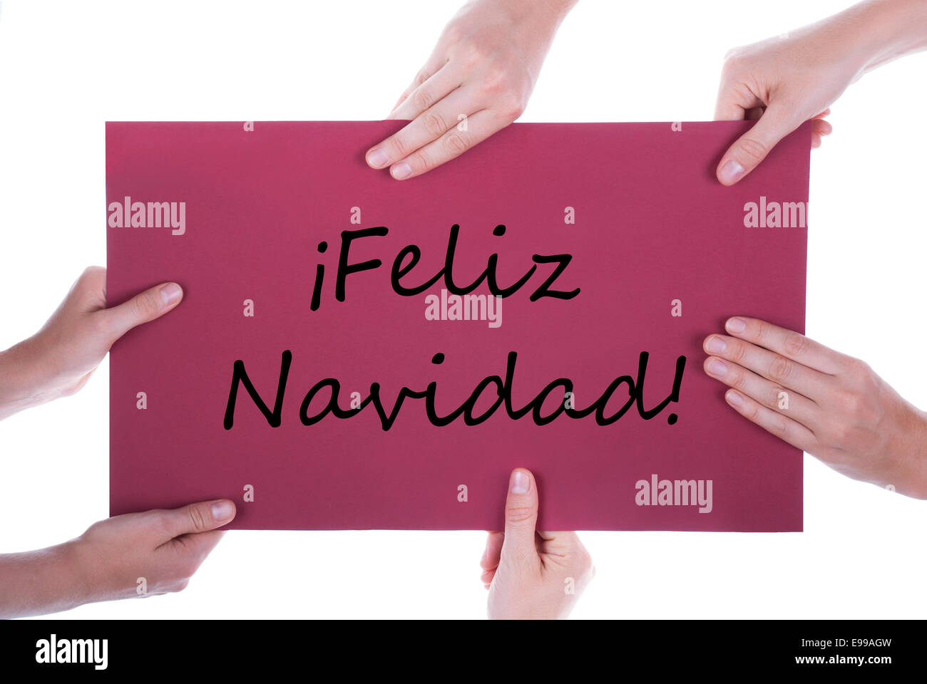 Many Hands Holding together a Sign on which stands the Spanish Words Feliz Navidad, which means Merry Christmas, Isolated Stock Photo