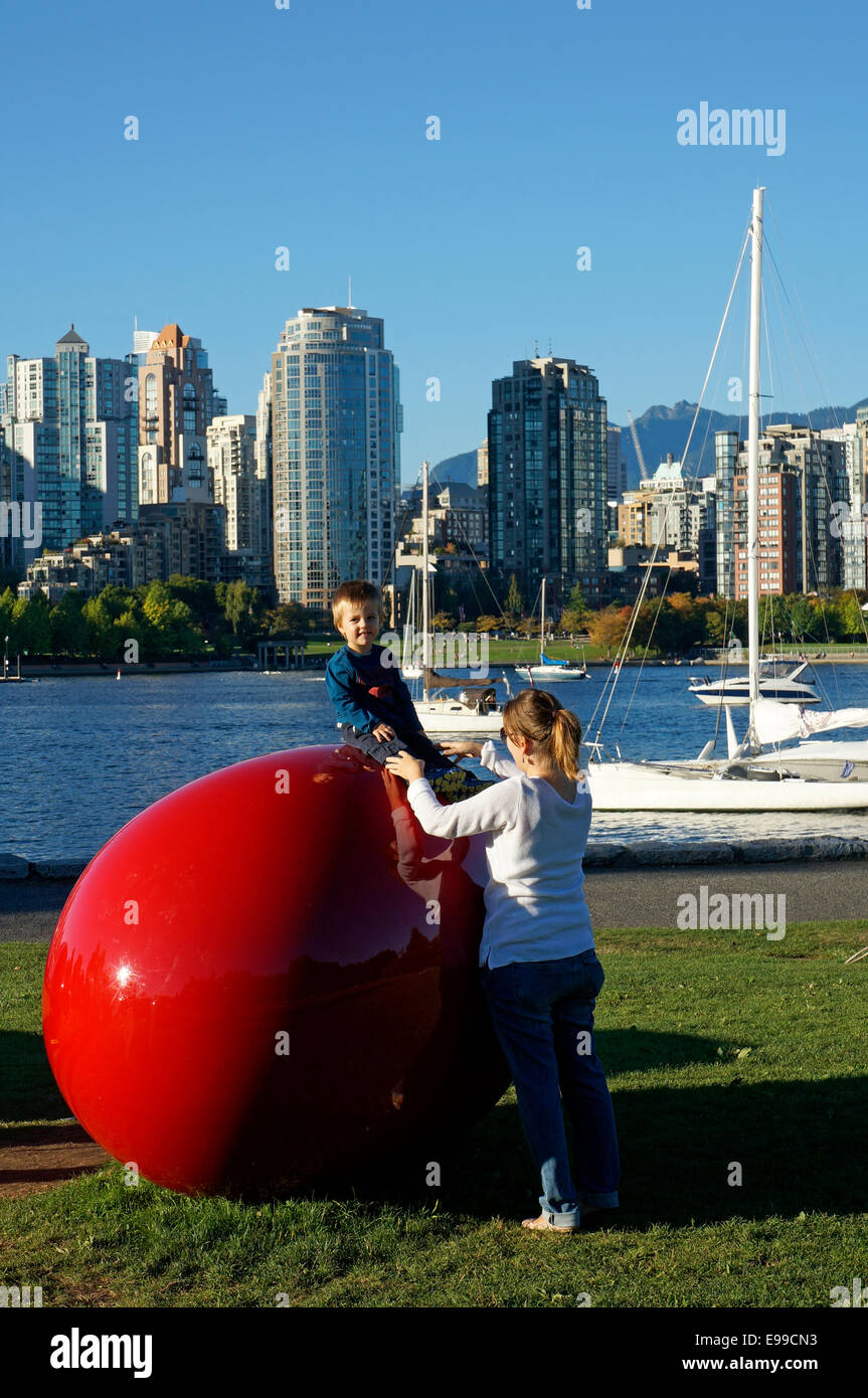 Young boy sitting on Love Your Beans sculpture by Cosimo Cavallaro, Charleson Park, False Creek, Vancouver, BC, Canada Stock Photo