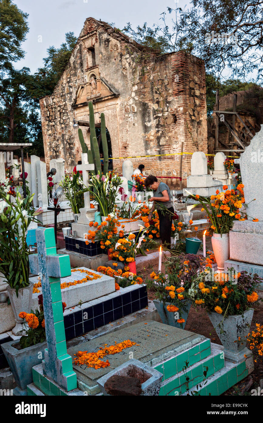 Mexican families light candles at the gravesite of relatives for Day of