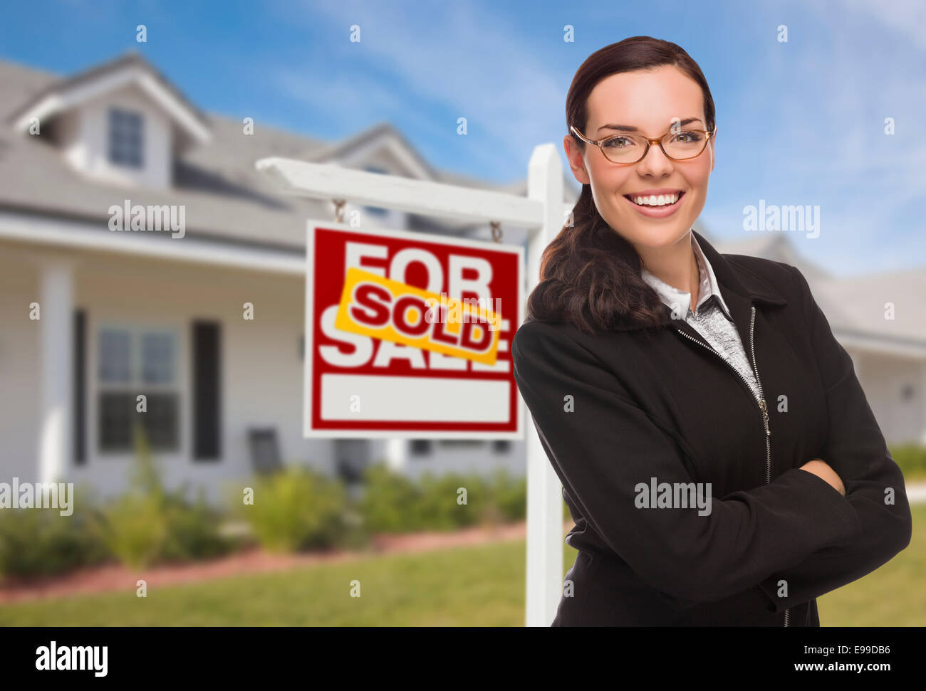 Attractive Mixed Race Woman in Front of House and Sold Real Estate Sign ...