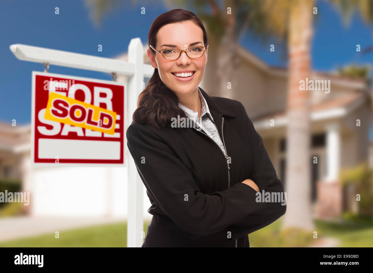 Attractive Mixed Race Woman in Front of House and Sold Real Estate Sign ...