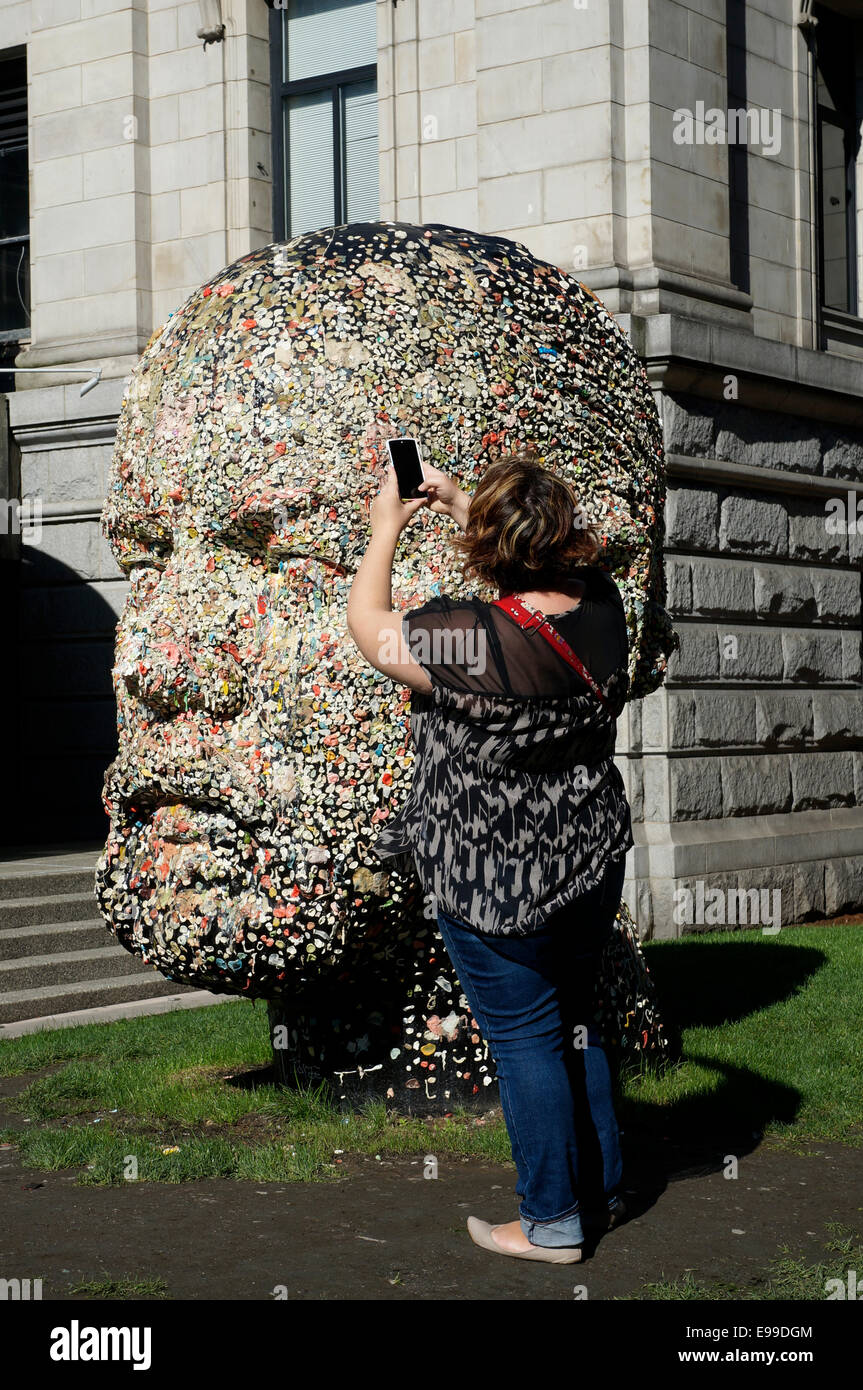 Woman using her cell phone to photograph Gumhead sculpture by Douglas  Coupland outside the Vancouver Art Gallery, Vancouver, BC Stock Photo -  Alamy