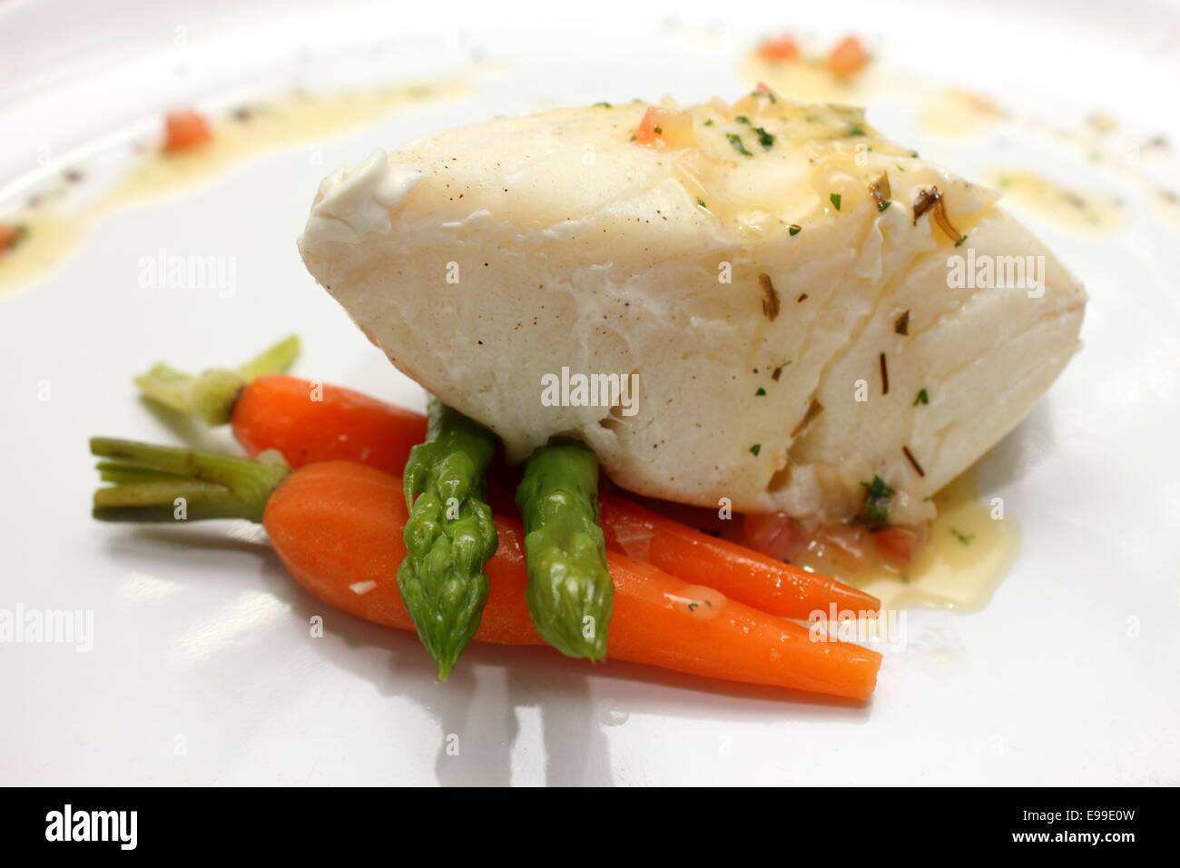 A grilled Pangasius fish steak, isolated on a white plate Stock Photo