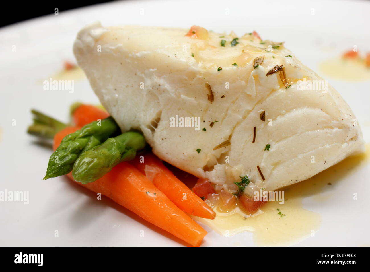 A grilled Pangasius fish steak, isolated on a white plate Stock Photo