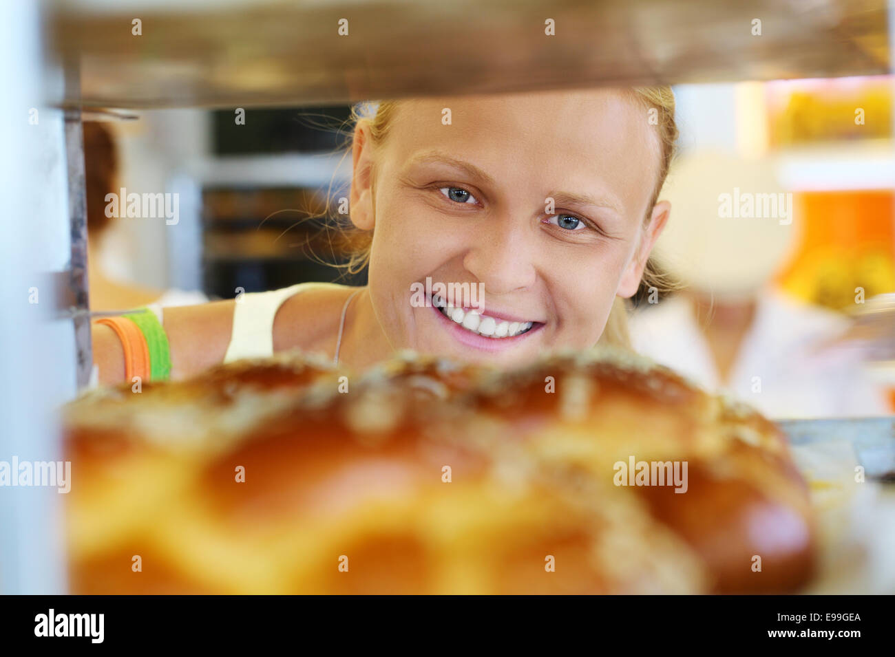 Happy woman looking at fresh bread in the shop Stock Photo