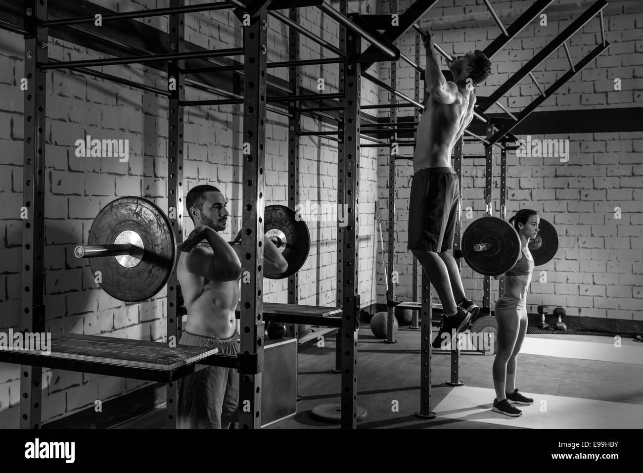 Barbell weight lifting group weightlifting workout exercise gym Stock