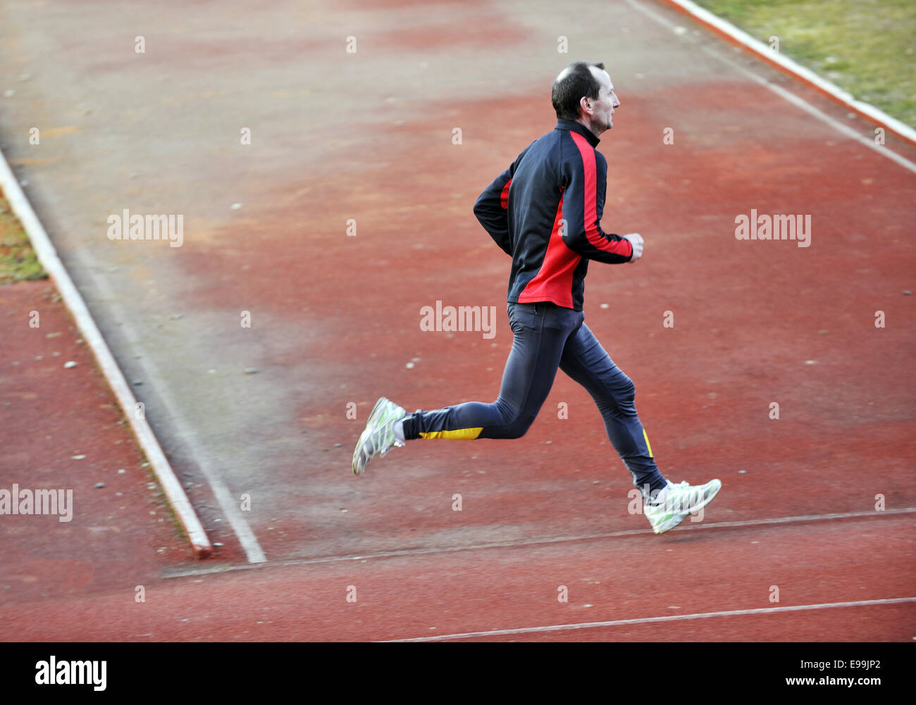adult man running on athletics track Stock Photo - Alamy