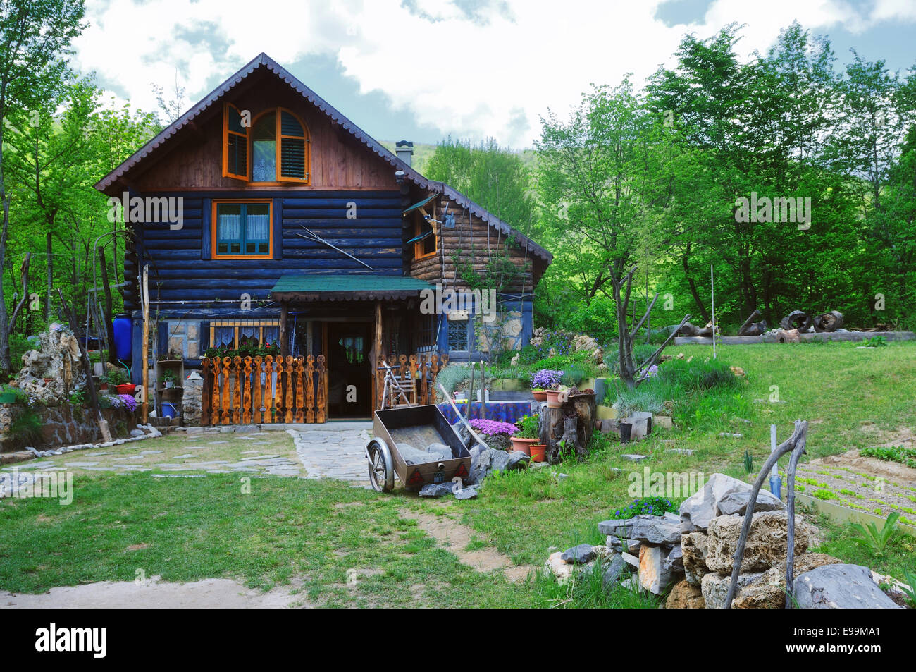 wooden country house with beutiful garden Stock Photo - Alamy