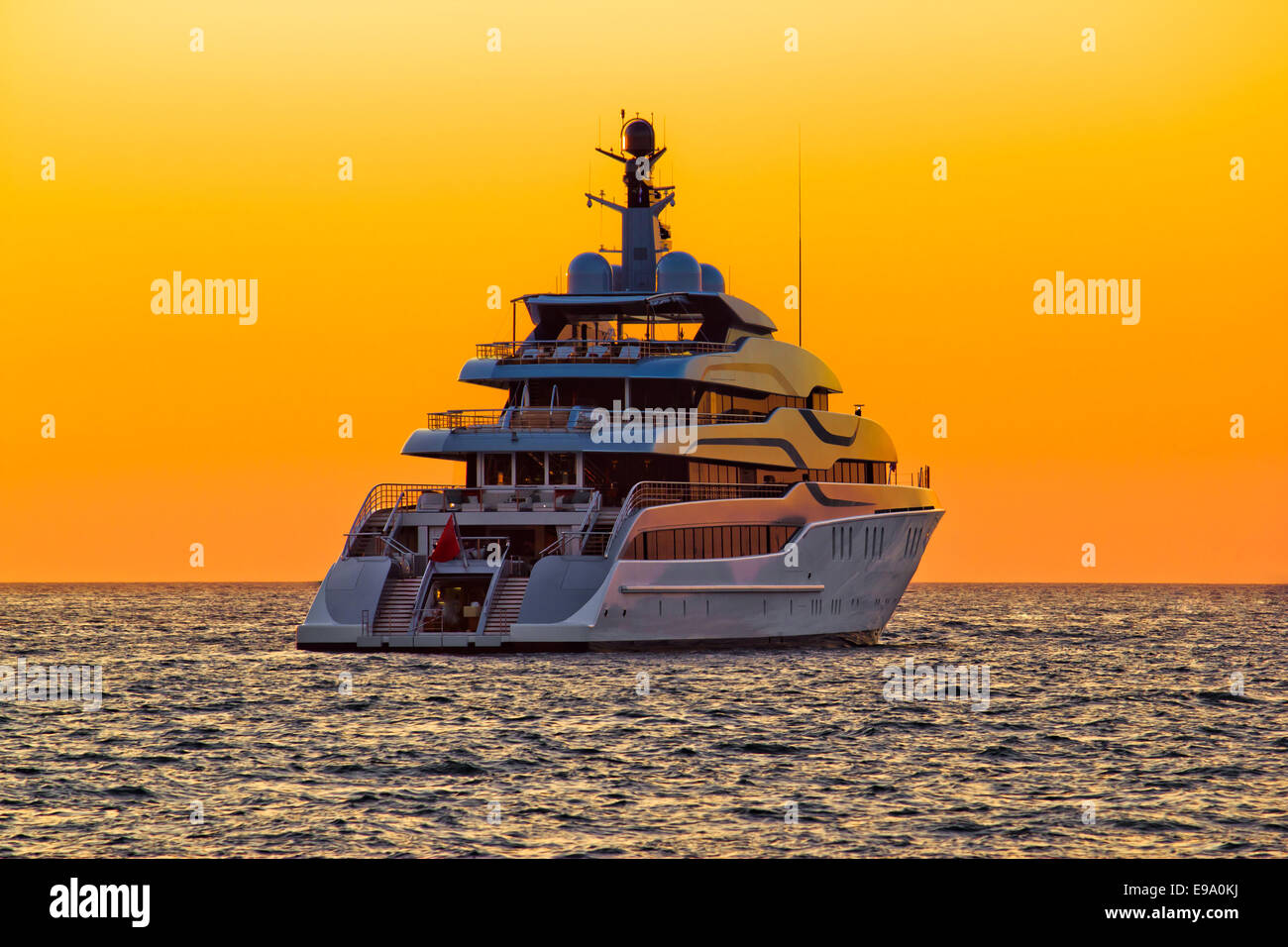 Luxury yacht on open sea at sunset Stock Photo - Alamy