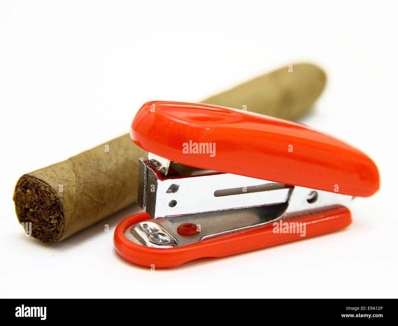 Red stapler and cigar Stock Photo