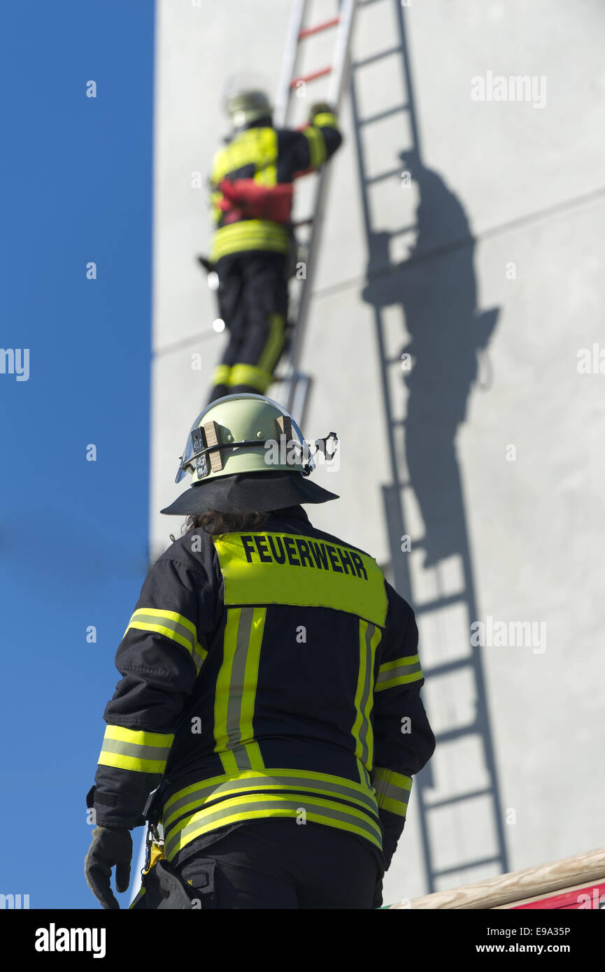 Rescuing a person by firefighters Stock Photo