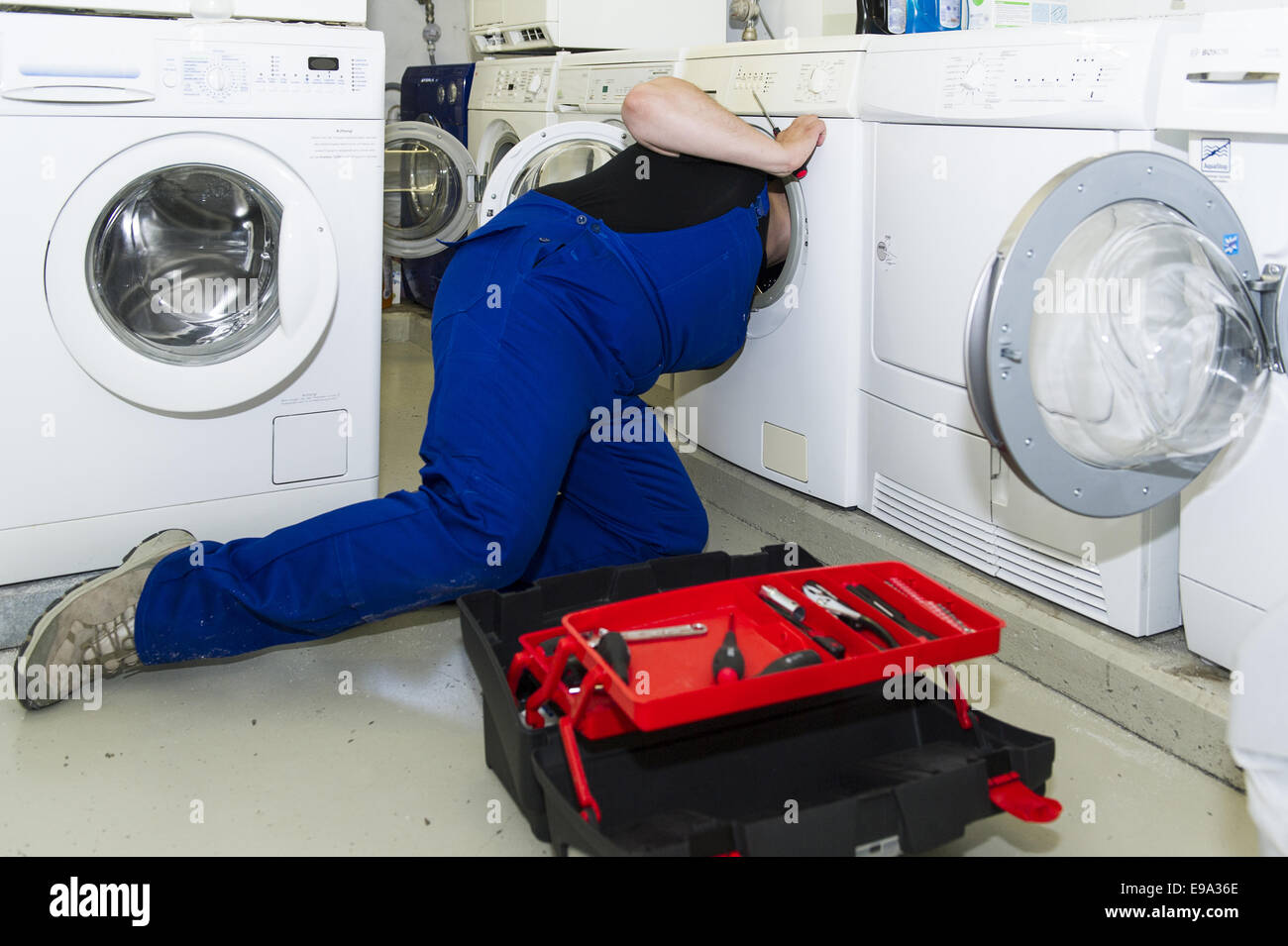 Technician repairing a washing machine Stock Photo Alamy