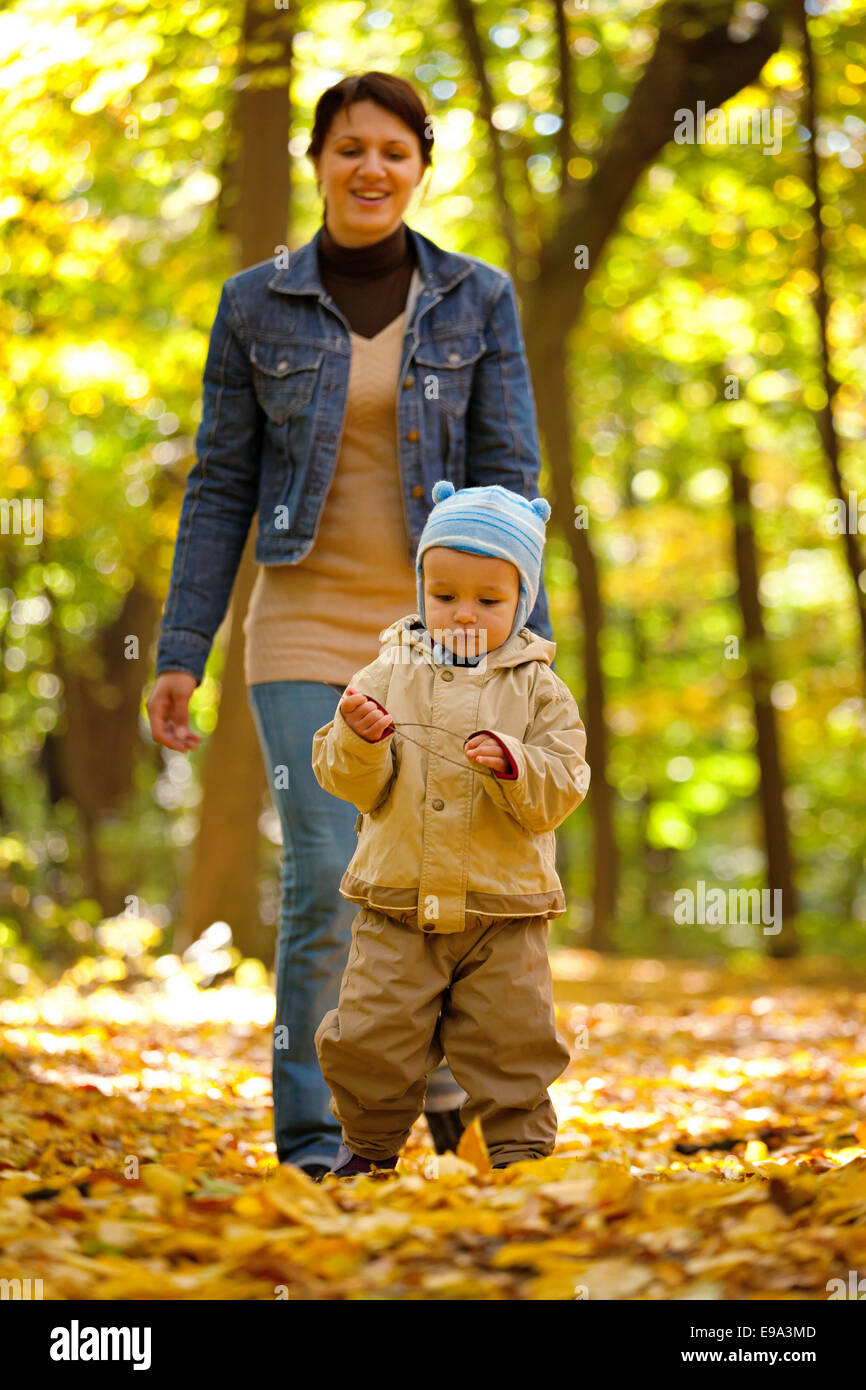 Happy young mother and her little sun in an autumn park Stock Photo - Alamy