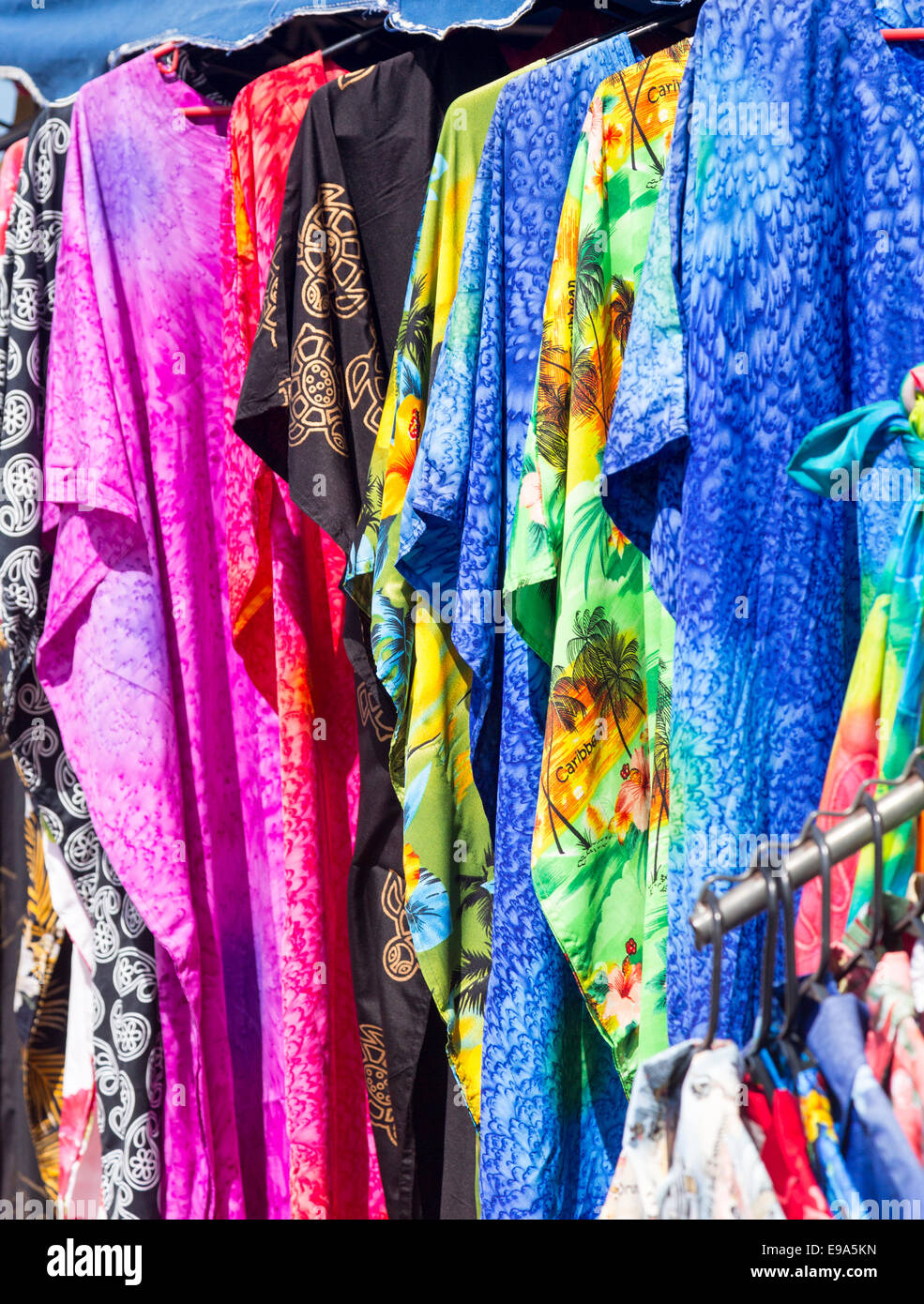 Clothing and fabrics in street market stall Stock Photo