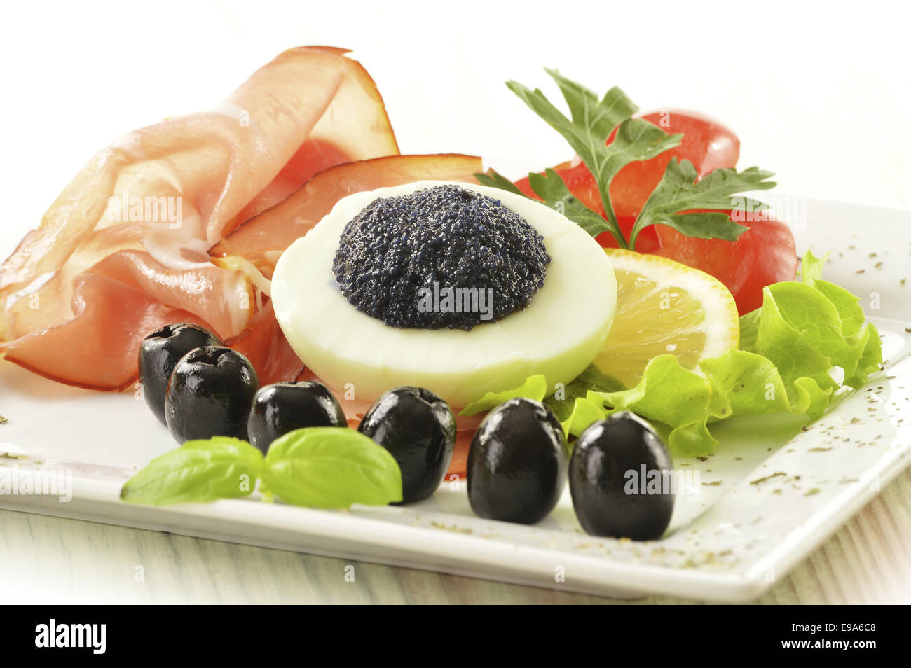 Egg with caviar and garnish Stock Photo