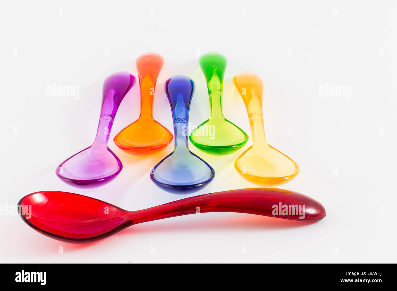 Colorful plastic spoons on white background Stock Photo - Alamy