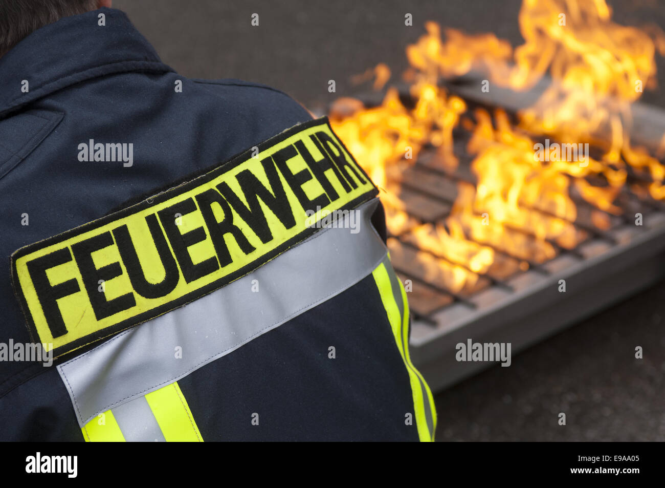 Fireman in front of a fire place Stock Photo