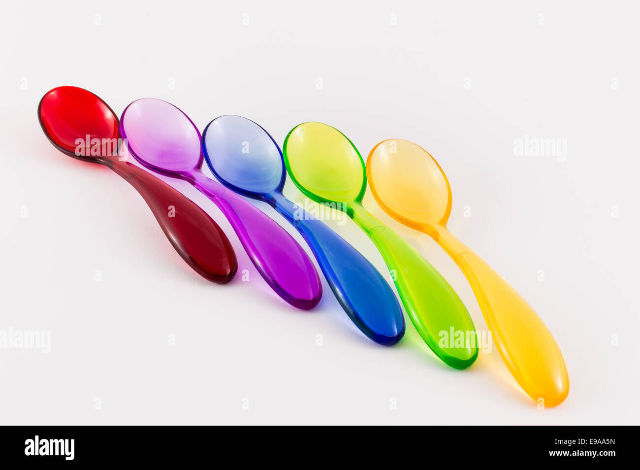 Colorful plastic spoons on white background Stock Photo - Alamy