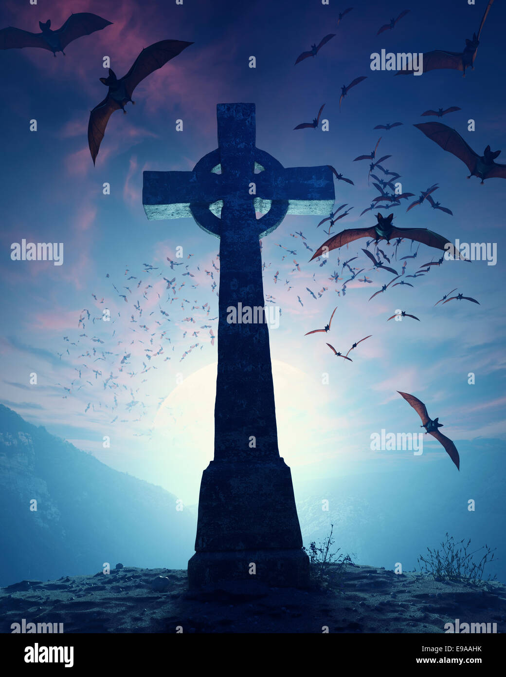 Celtic Cross with swarm of bats invading against misty moon Stock Photo