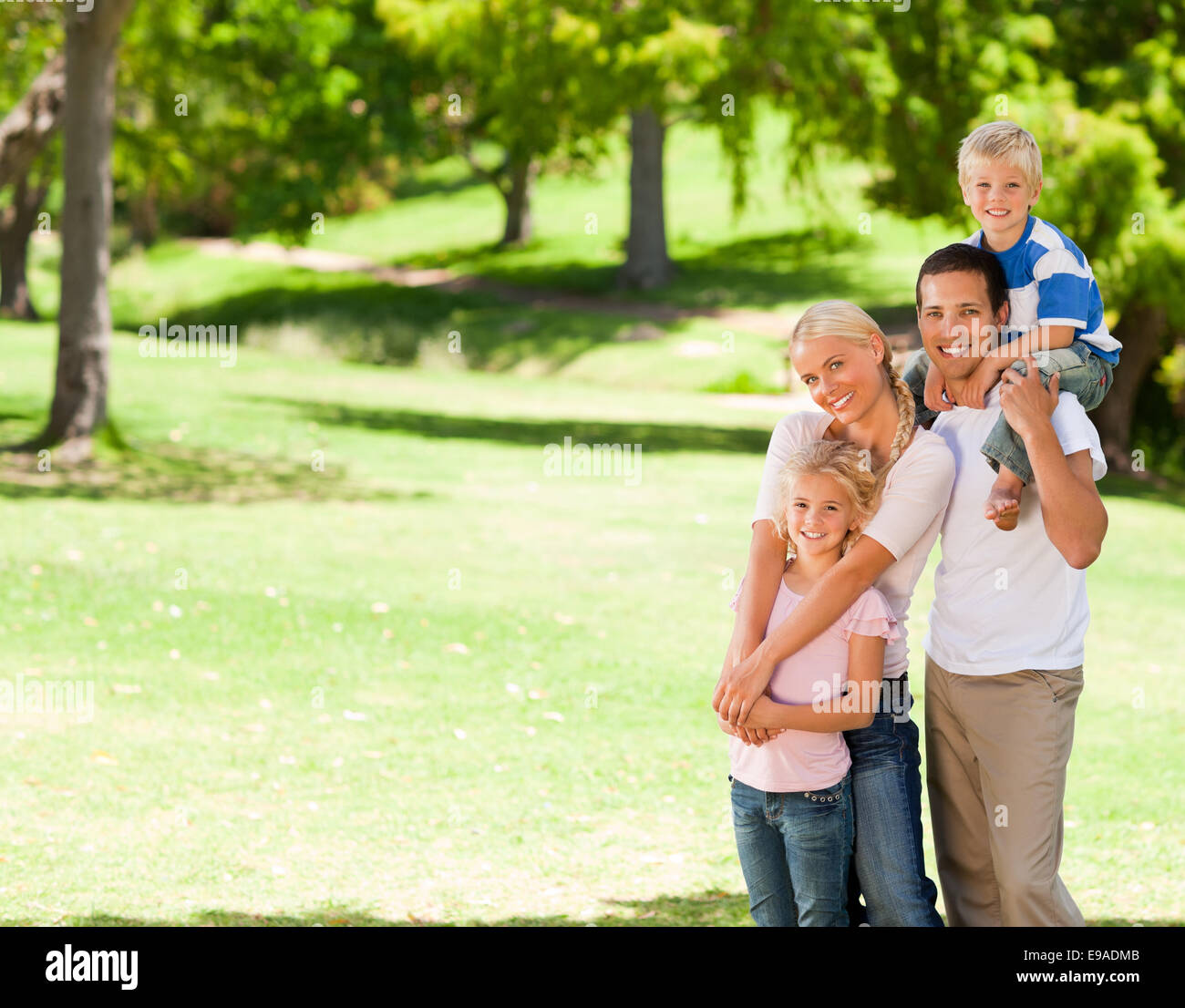 Happy family in the park Stock Photo - Alamy