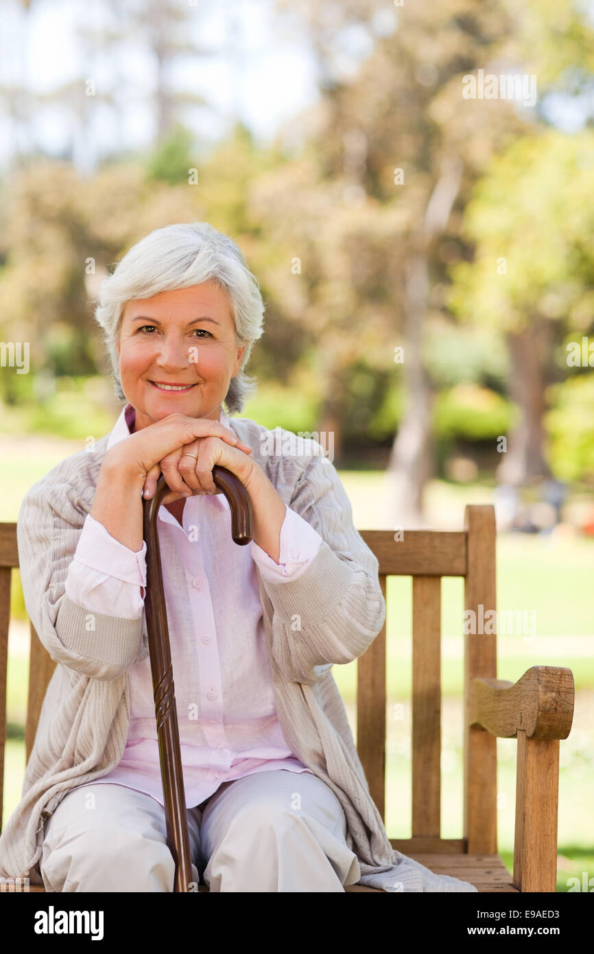 Older woman sitting walking stick hi-res stock photography and images ...