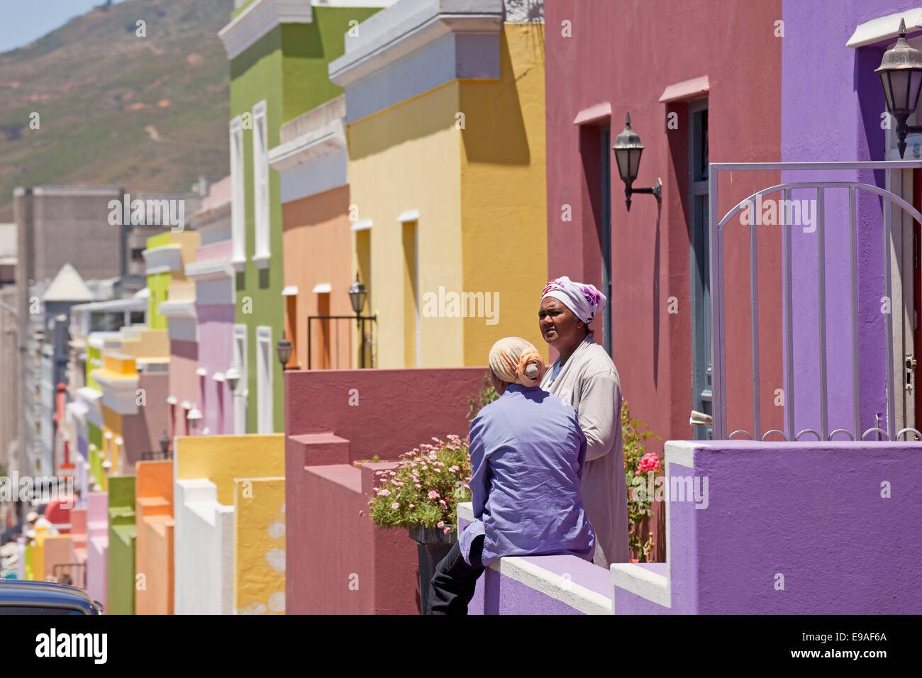 local woman and their typical coloured homes in the quarter Cape Malay Bo-Kaap, Cape Town, Western Cape, South Africa Stock Photo