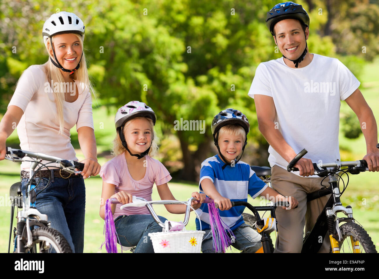 Family in the park with their bikes Stock Photo - Alamy