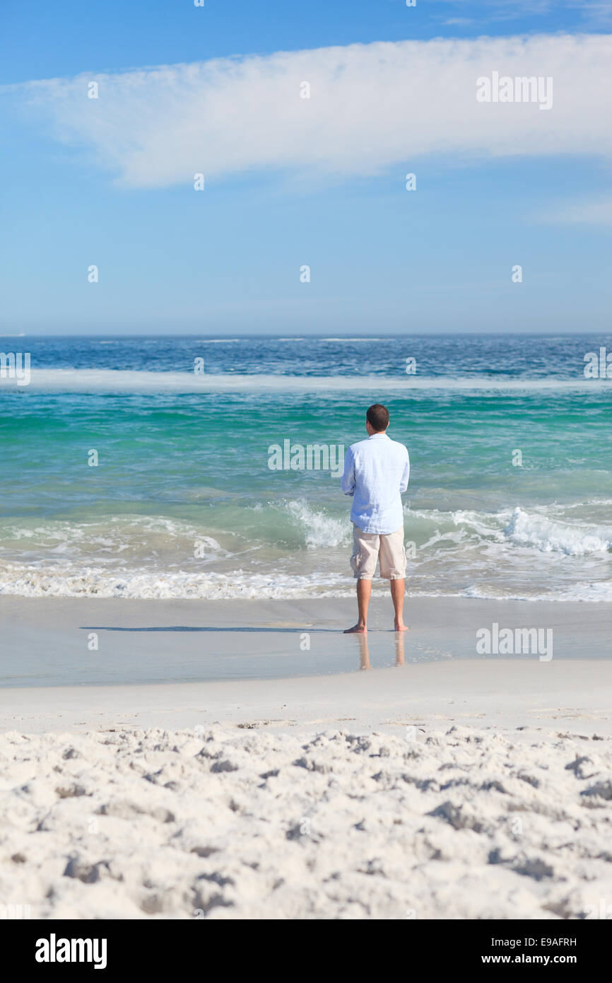 Man walking on the beach Stock Photo - Alamy