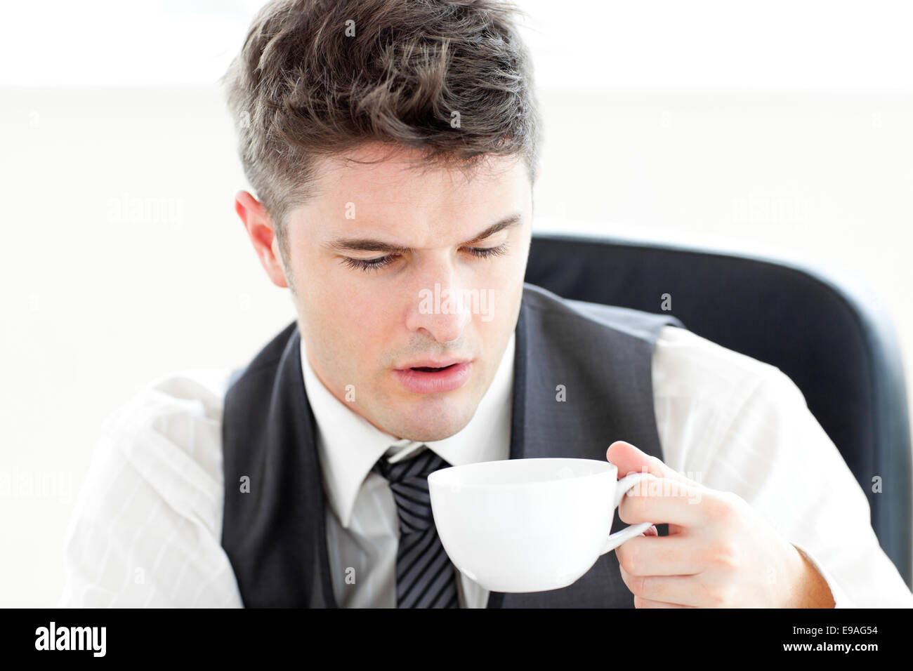 Tired businessman drinking coffee Stock Photo Alamy