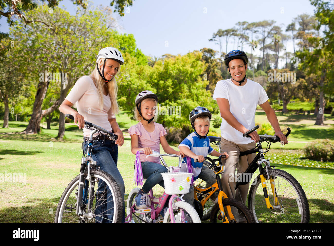 Family in the park with their bikes Stock Photo - Alamy