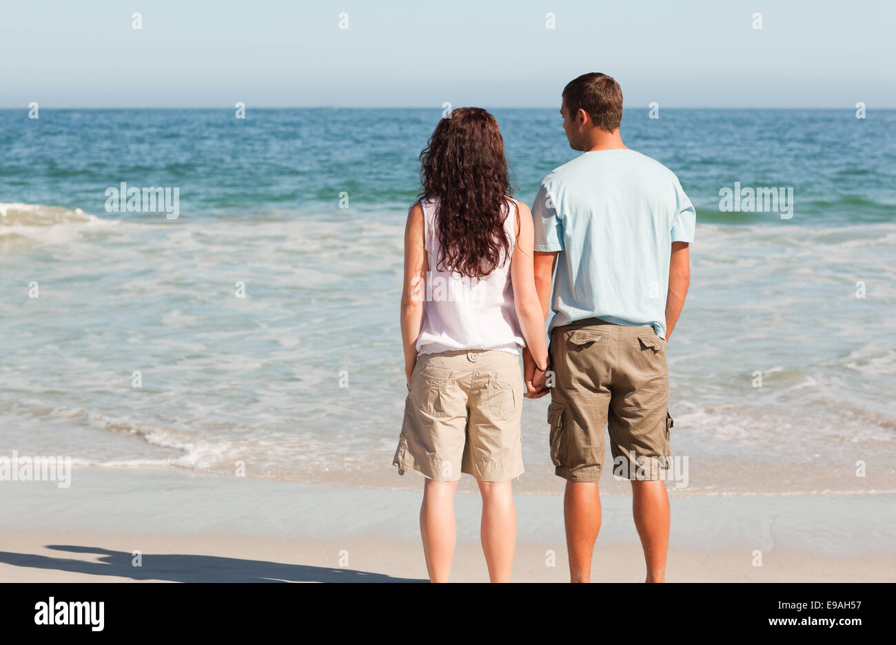 Lovers walking on the beach Stock Photo Alamy