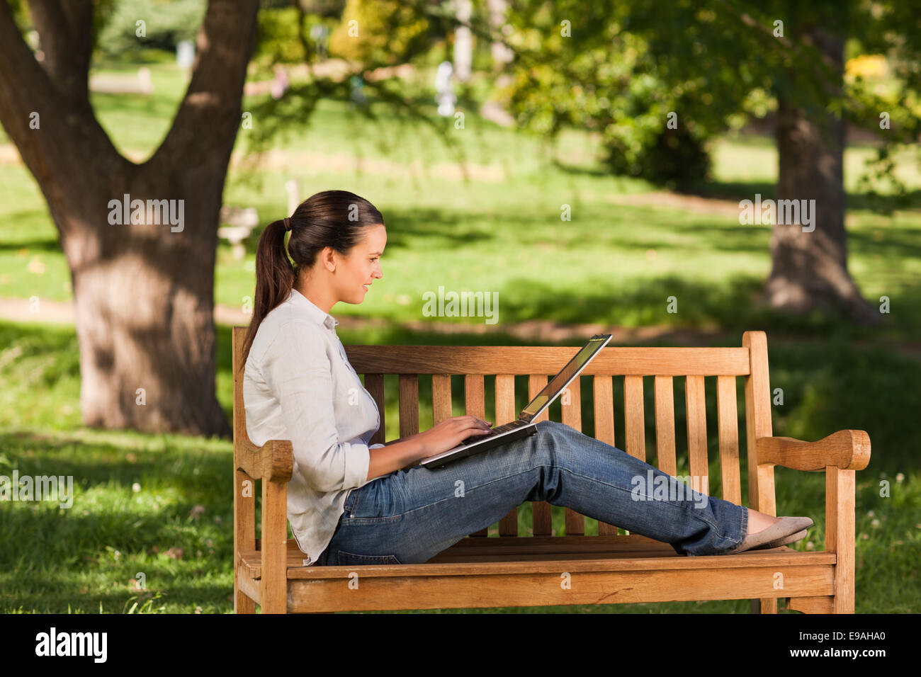 Young woman working on her laptop Stock Photo - Alamy