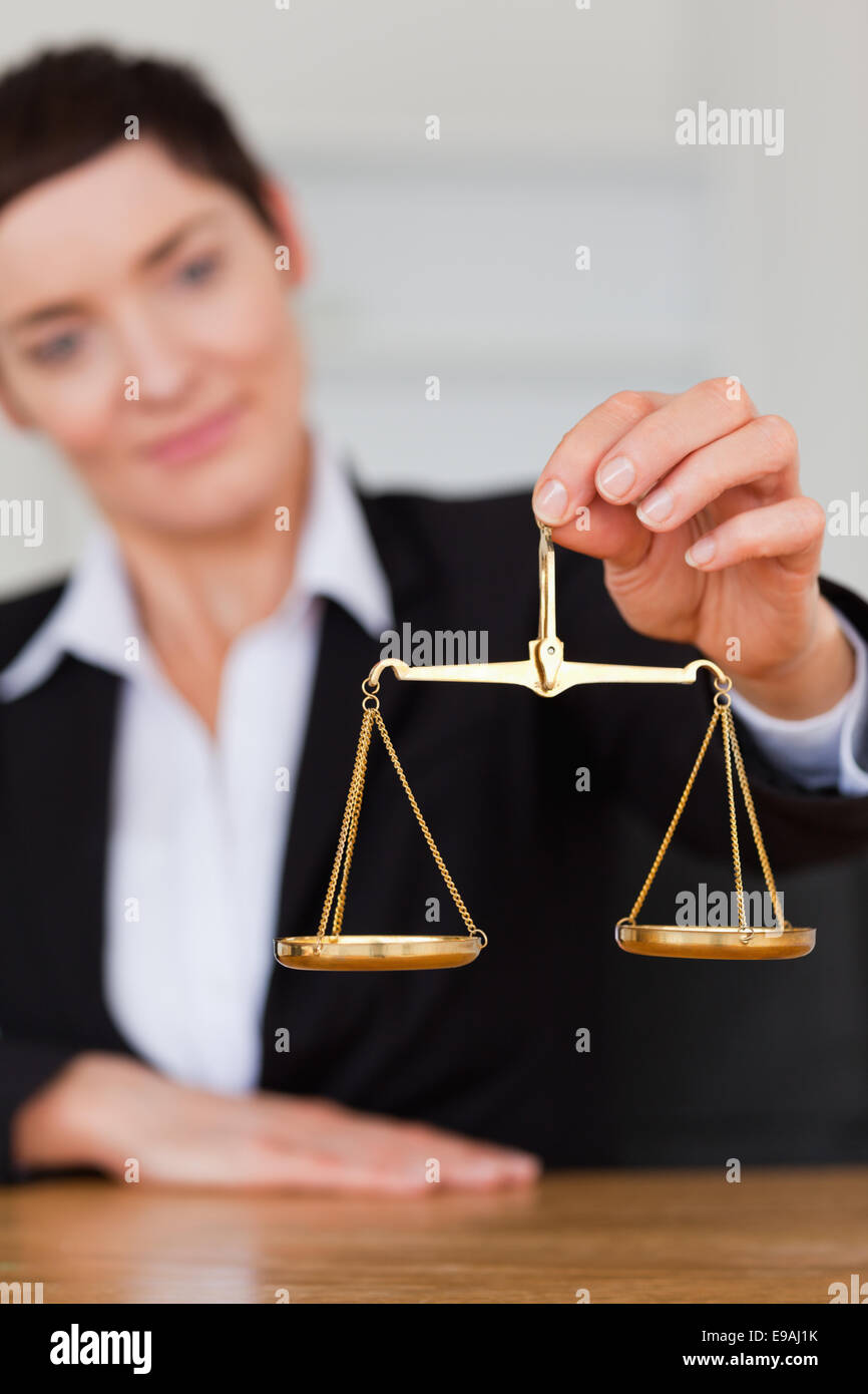 Serious woman holding the justice scale Stock Photo