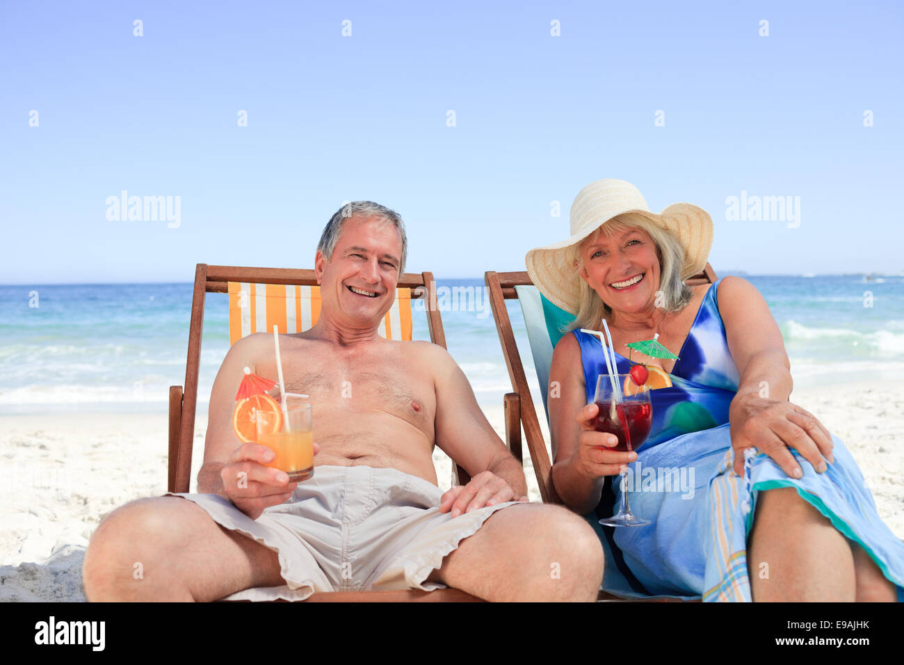 Senior couple sitting on deck chairs Stock Photo - Alamy