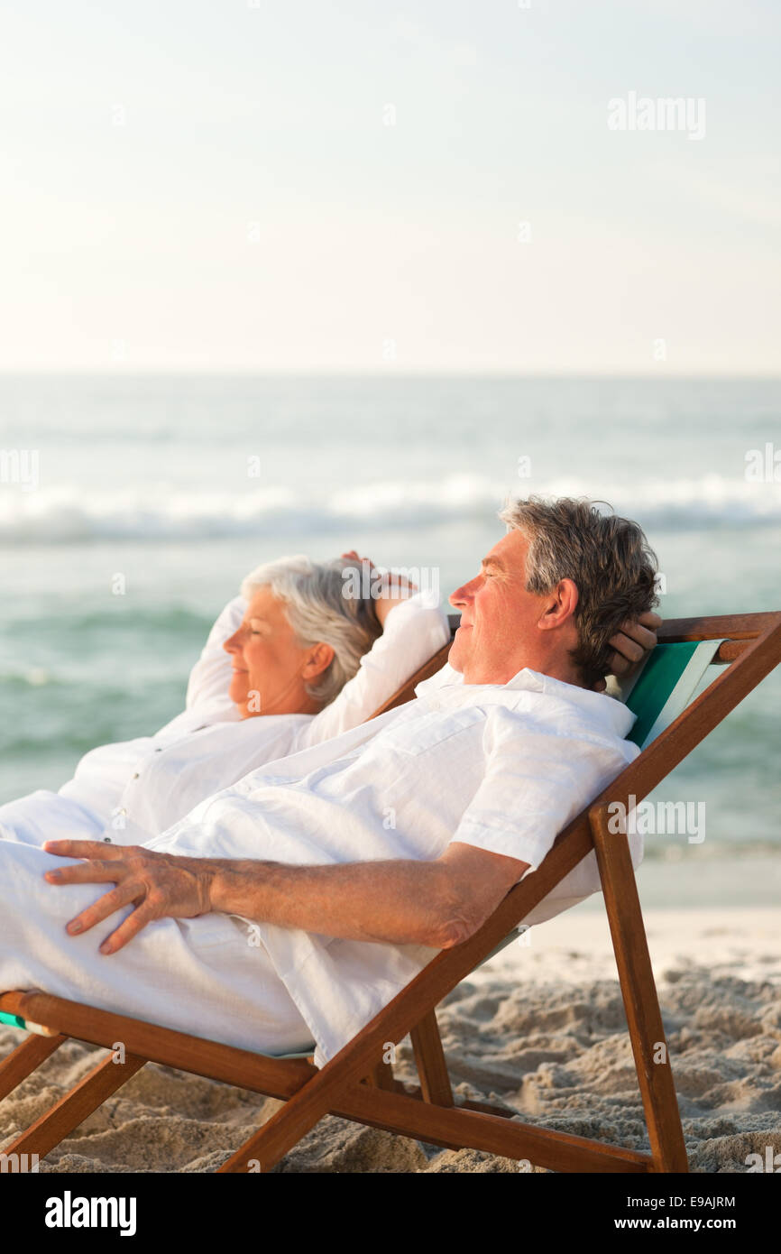 Elderly couple relaxing in their deck chairs Stock Photo Alamy