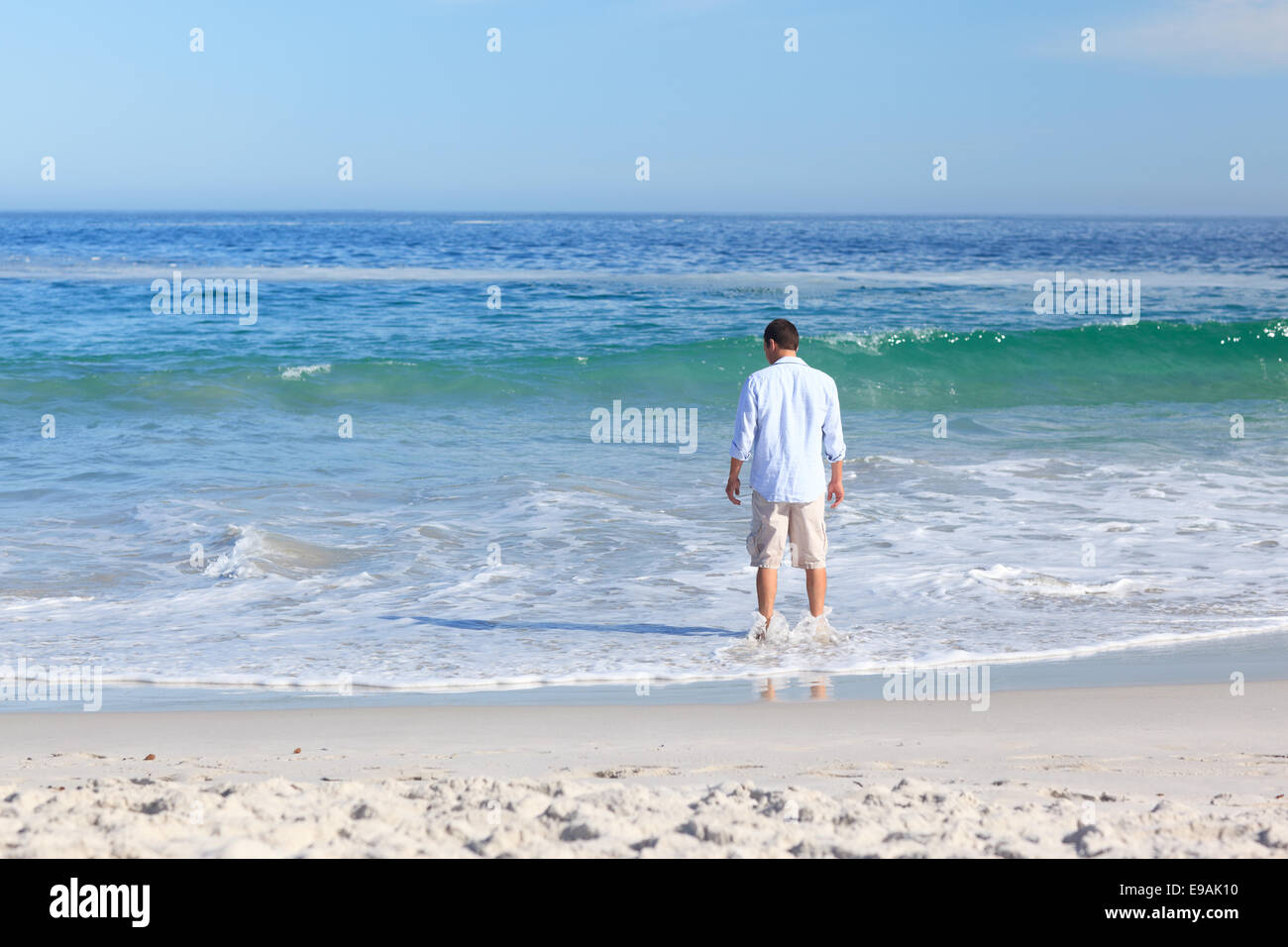 Man walking on the beach Stock Photo - Alamy