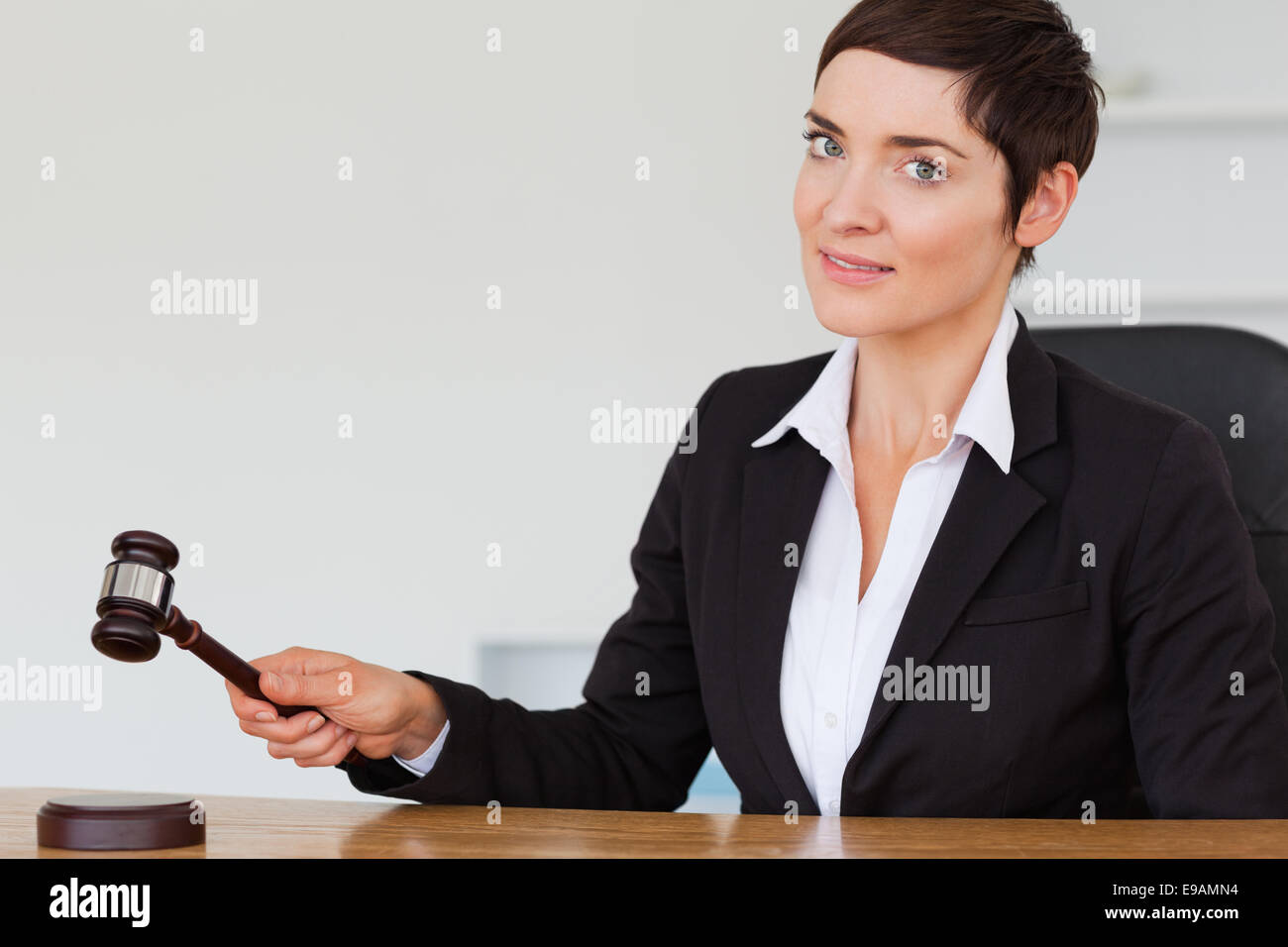 Woman knocking a gavel Stock Photo