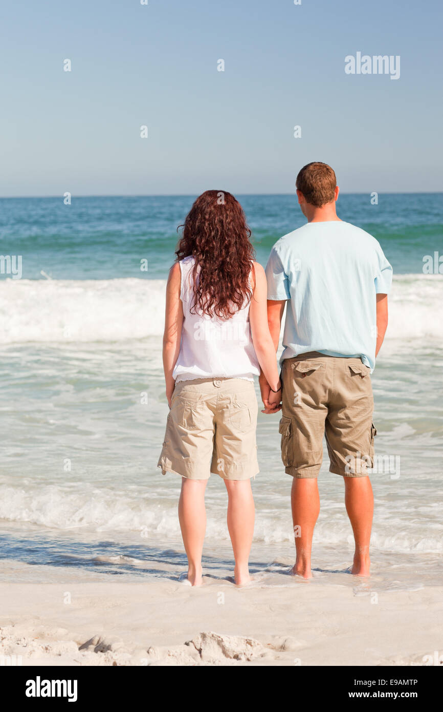 Lovers walking on the beach Stock Photo Alamy