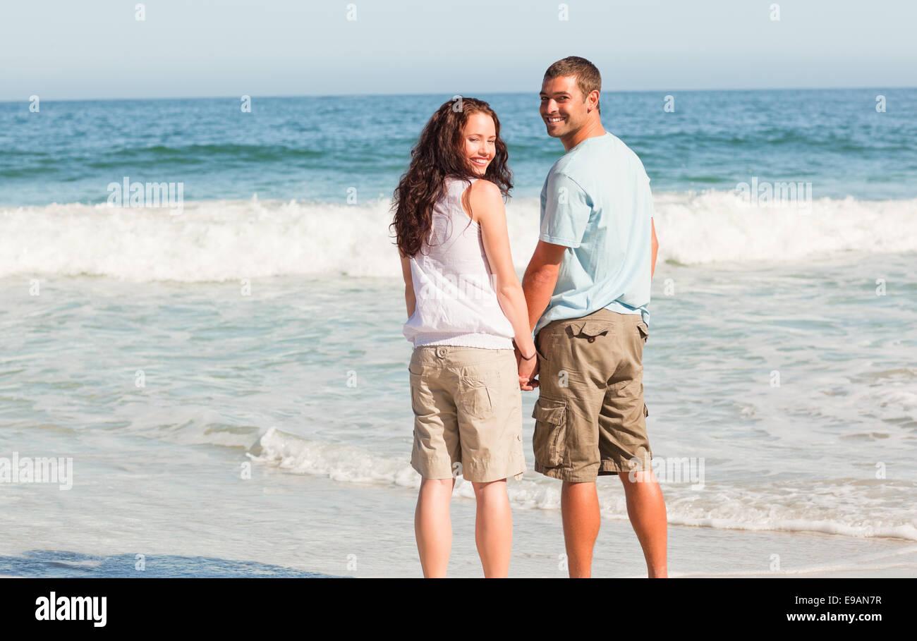 Lovers walking on the beach Stock Photo Alamy