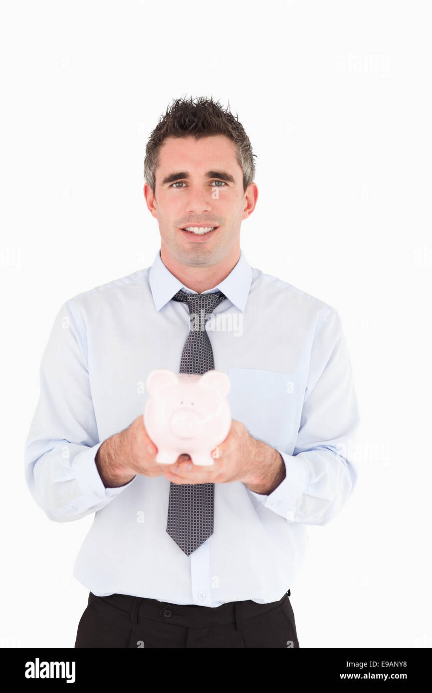 Man showing a piggy bank Stock Photo - Alamy