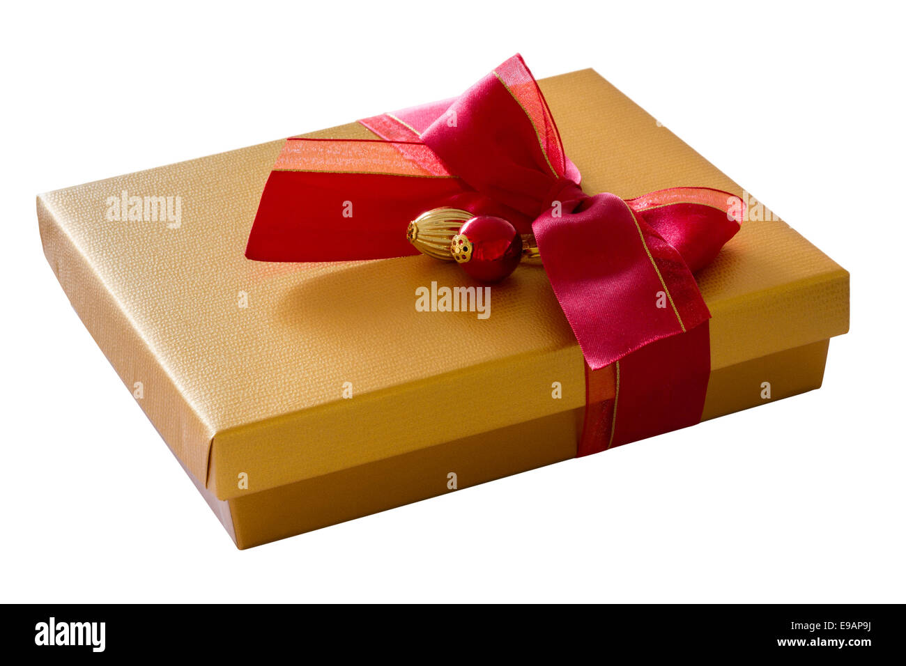 Gold color box with red ribbon in bow Stock Photo