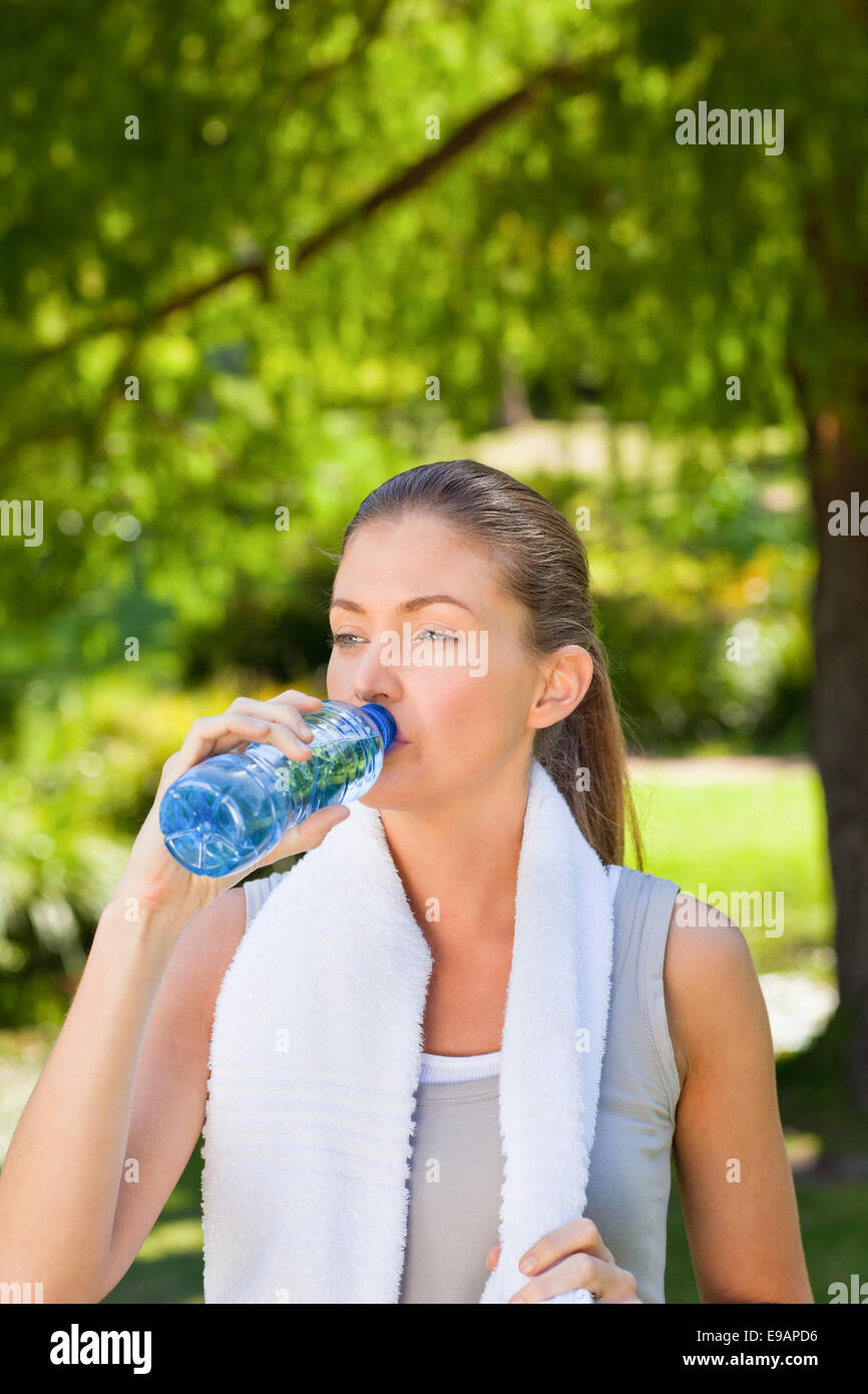 Woman drinking water after the gym Stock Photo - Alamy