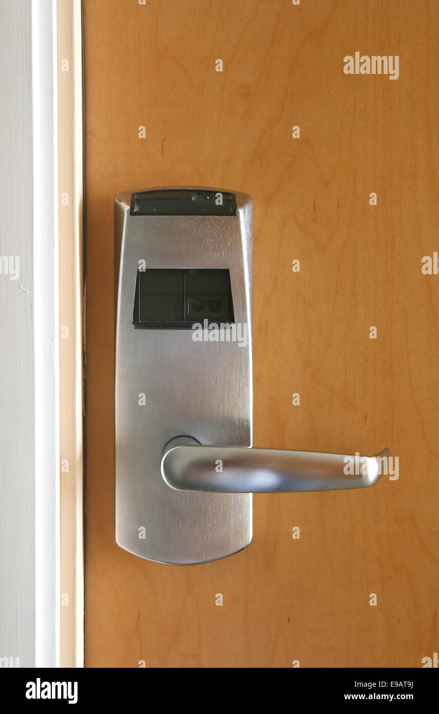 Keycard electronic lock on wooden door Stock Photo