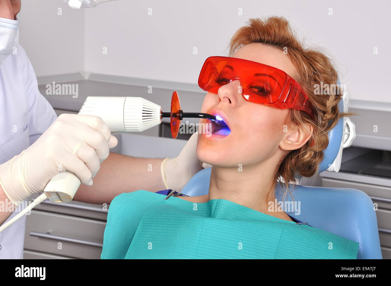 girl teeth stopping treatment with dental curing ultraviolet light equipment Stock Photo Alamy