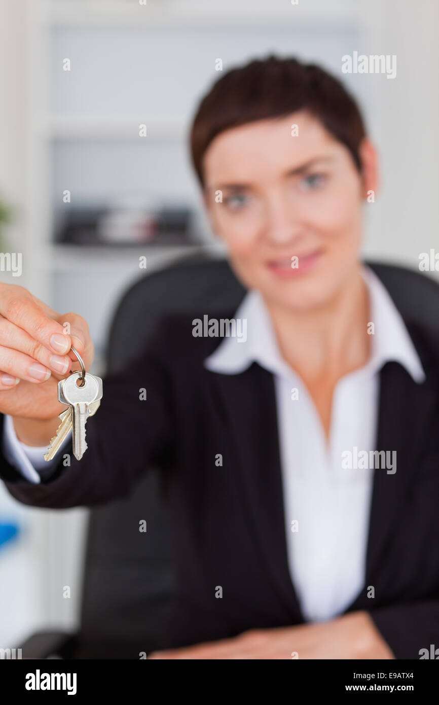 Portrait of a businesswoman showing keys Stock Photo - Alamy