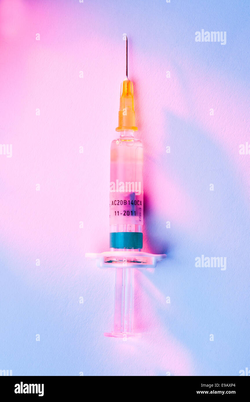 syringe lit by red light Stock Photo - Alamy