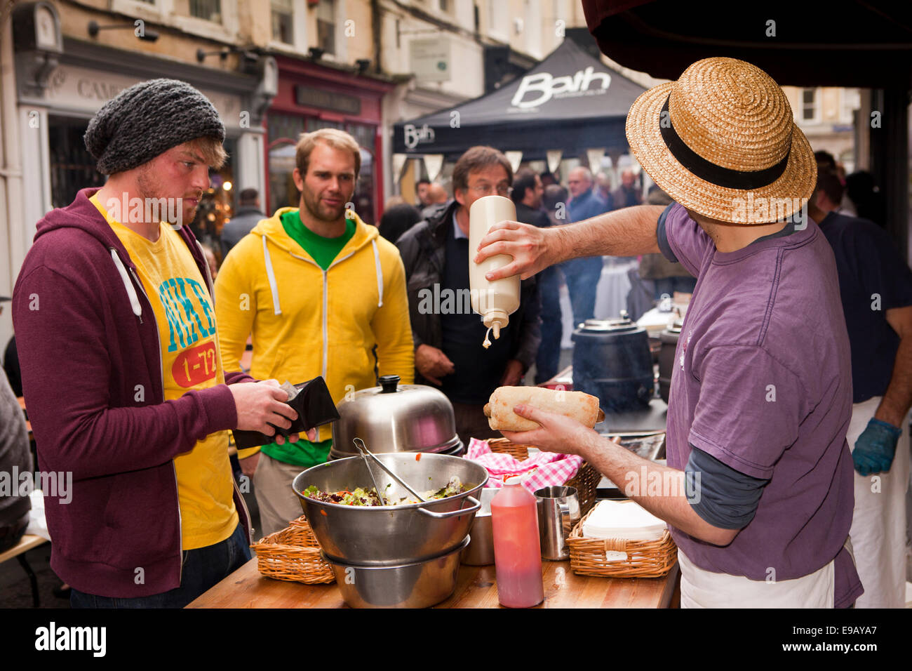 UK, England, Wiltshire, Bath, Green Street,  Great Bath Feast food festival street Party man at gourmet hot dog stall Stock Photo