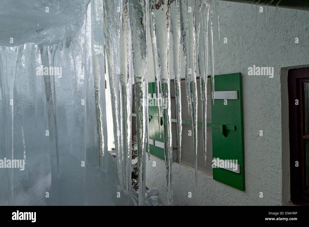 Icicles on a house in the Alps Stock Photo